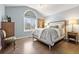 Bedroom with large window and light-colored walls, featuring light-colored decor and hardwood floors at 3749 White Bay Dr, Highlands Ranch, CO 80126