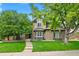 Charming two-story home with a well-manicured lawn and mature trees, creating curb appeal at 3749 White Bay Dr, Highlands Ranch, CO 80126