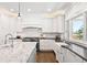Modern kitchen with white cabinets, marble countertops, and stainless steel appliances at 3749 White Bay Dr, Highlands Ranch, CO 80126