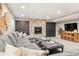 Cozy living room features a stone fireplace, built-in cabinets, and plush seating at 3749 White Bay Dr, Highlands Ranch, CO 80126