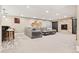 Spacious living room featuring a stone fireplace, built-in cabinets, and plush sectional sofa at 3749 White Bay Dr, Highlands Ranch, CO 80126
