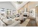 Bright living room featuring a brick fireplace, built-in shelves, and large windows at 3749 White Bay Dr, Highlands Ranch, CO 80126