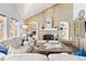 Comfortable living room featuring a brick fireplace, high vaulted ceilings and lots of natural light at 3749 White Bay Dr, Highlands Ranch, CO 80126