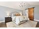 The main bedroom features vaulted ceilings and a sliding barn door to the bathroom at 3749 White Bay Dr, Highlands Ranch, CO 80126