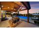 Outdoor dining and kitchen area overlooking a pool, spa, and lounge area, perfect for outdoor living at 3749 White Bay Dr, Highlands Ranch, CO 80126