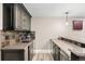 Modern wet bar with sleek cabinetry, stylish countertops, and tile backsplash at 3749 White Bay Dr, Highlands Ranch, CO 80126