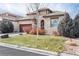 Charming stone home featuring a well-manicured lawn and a quaint, welcoming entrance and a two car garage at 16 Willowcroft Dr, Littleton, CO 80123