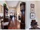 Inviting hallway with hardwood floors, elegant decor, and an antique grandfather clock at 16 Willowcroft Dr, Littleton, CO 80123