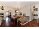 Open landing area with hardwood floors, wood banister and decorative lighting fixtures at 16 Willowcroft Dr, Littleton, CO 80123