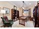 Cozy office with built-in bookshelves, a wooden desk and a comfortable armchair at 16 Willowcroft Dr, Littleton, CO 80123