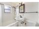 Clean bathroom with a shower and tub combo, vintage fixtures, and natural light at 3790 W 54Th Ave, Denver, CO 80221