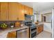 Modern kitchen with stainless steel appliances, granite countertops, and light wood cabinetry at 3790 W 54Th Ave, Denver, CO 80221