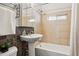 Bathroom features tile accents, a pedestal sink, and a shower-tub combination at 1335 S Holly St, Denver, CO 80222