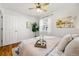 This bedroom features a ceiling fan, neutral paint, hardwood floors, and art at 1335 S Holly St, Denver, CO 80222