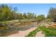 Scenic creek with clear water, sandy beach, and lush greenery on the banks at 1335 S Holly St, Denver, CO 80222