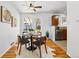 Cozy dining area with wood floors, ceiling fan, and view into kitchen at 1335 S Holly St, Denver, CO 80222