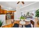 Open concept dining area with hardwood floors flowing into adjacent living room and kitchen at 1335 S Holly St, Denver, CO 80222