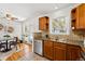 Bright kitchen featuring wooden cabinets, stainless steel appliances and view into adjacent dining area at 1335 S Holly St, Denver, CO 80222