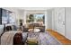 Bright living room featuring a large window, hardwood floors, and contemporary furniture at 1335 S Holly St, Denver, CO 80222