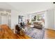 Bright living room with hardwood floors, large window, and comfortable seating at 1335 S Holly St, Denver, CO 80222
