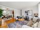 Inviting living room with hardwood floors, a stylish area rug, and a comfortable sofa at 1335 S Holly St, Denver, CO 80222