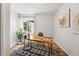 Home office setup with a wooden desk, chair, artwork, and natural light at 1335 S Holly St, Denver, CO 80222