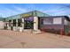 Ester's building with outdoor seating area, landscaping, and street front parking at 1335 S Holly St, Denver, CO 80222
