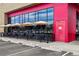 Building exterior with a line of outdoor tables and chairs with black umbrellas at 1335 S Holly St, Denver, CO 80222