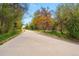 Cement walking path surrounded by trees offering a picturesque and inviting outdoor recreational space at 1335 S Holly St, Denver, CO 80222