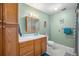 Well-lit bathroom with wood cabinets, white countertops, and tiled floor at 309 E Highline Cir # 102, Centennial, CO 80122