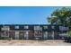 Exterior shot of brick apartment building with balconies on a clear day at 309 E Highline Cir # 102, Centennial, CO 80122