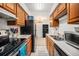 Galley kitchen with white countertops and stainless steel appliances at 309 E Highline Cir # 102, Centennial, CO 80122