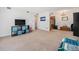 Spacious carpeted living room featuring a TV, wall decor, and storage at 309 E Highline Cir # 102, Centennial, CO 80122