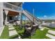 Backyard patio with outdoor furniture, a fire pit, string lights, and staircase leading to the second floor at 6860 S Yantley Ct, Aurora, CO 80016