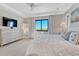 Serene bedroom featuring tray ceilings, natural light, and plush bedding at 6860 S Yantley Ct, Aurora, CO 80016