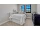 Cozy bedroom with soft neutral tones, plush carpeting, and ample natural light from two windows at 6860 S Yantley Ct, Aurora, CO 80016