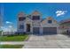 Charming two-story home with stone accents, a well-manicured lawn, and a spacious driveway at 6860 S Yantley Ct, Aurora, CO 80016