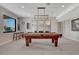 Spacious game room featuring a pool table, stylish lighting, and entertainment space at 6860 S Yantley Ct, Aurora, CO 80016