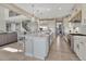 Open-concept kitchen featuring a large center island, stainless steel appliances, and sleek white cabinetry at 6860 S Yantley Ct, Aurora, CO 80016