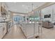 Spacious kitchen featuring a large island, white cabinets, and an open layout leading to the living area at 6860 S Yantley Ct, Aurora, CO 80016