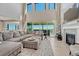 Bright living room featuring a fireplace, large sectional sofa, and sliding glass doors to the backyard at 6860 S Yantley Ct, Aurora, CO 80016