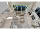 Open living room with high ceilings, a fireplace, large sectional, and views of the backyard patio at 6860 S Yantley Ct, Aurora, CO 80016