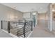 Upstairs loft area featuring modern railing, neutral paint and carpet, chandelier, and desk nook at 6860 S Yantley Ct, Aurora, CO 80016