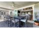 Covered outdoor dining area with large table, modern chairs, and stunning views of the living room at 6860 S Yantley Ct, Aurora, CO 80016