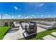 Outdoor patio featuring stylish lounge seating, a modern fire pit, and a serene water feature at 6860 S Yantley Ct, Aurora, CO 80016