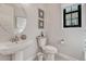 Clean and bright powder room featuring a pedestal sink, modern fixtures, and neutral decor at 6860 S Yantley Ct, Aurora, CO 80016