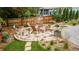 Backyard with flagstone patio and built-in fire pit surrounded by Adirondack chairs at 8167 S Wabash Ct, Centennial, CO 80112