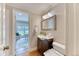 Bright bathroom featuring a vanity with mirror, and hardwood flooring at 8167 S Wabash Ct, Centennial, CO 80112