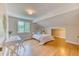 Comfortable bedroom with a dormer window, hardwood floors, and desk area at 8167 S Wabash Ct, Centennial, CO 80112
