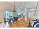 Open floor plan of dining area featuring chandelier, leading to living room and staircase at 8167 S Wabash Ct, Centennial, CO 80112